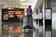 Man Driving Floor Scrubber Or Floor Cleaning Device In Airport