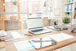 © Seventyfour - Background image of modern office interior with laptop on wooden table, workplace design concept, copy space