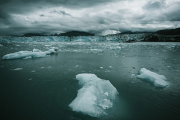 Columbia glacier, Alaska, passing through ice filled waters and mountains