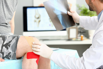 Doctor with patient holding xray shot prescribing treatment