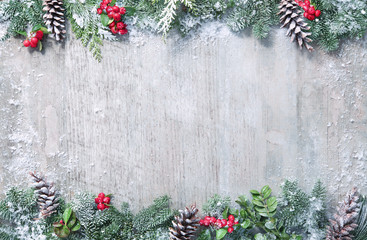 Wall Mural - christmas and new year background with fir branches and snowfall on wooden white board