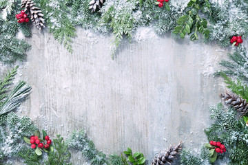 Wall Mural - christmas and new year background with fir branches and snowfall on wooden white board