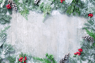 Wall Mural - christmas and new year background with fir branches and snowfall on wooden white board