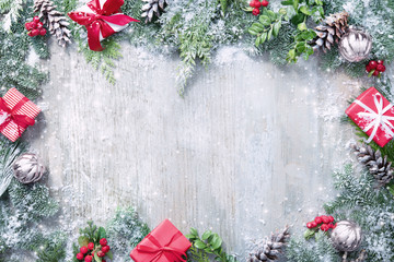 Wall Mural - christmas and new year background with fir branches and snowfall on wooden white board