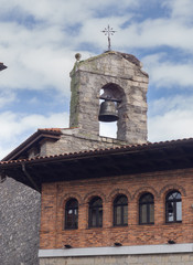 Stone church bell tower and arched windows in Orduña, Basque Country