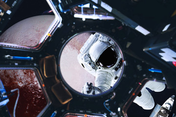 Wall Mural - astronaut near planet pluto of solar system in space with far galaxy on the background. view from sp