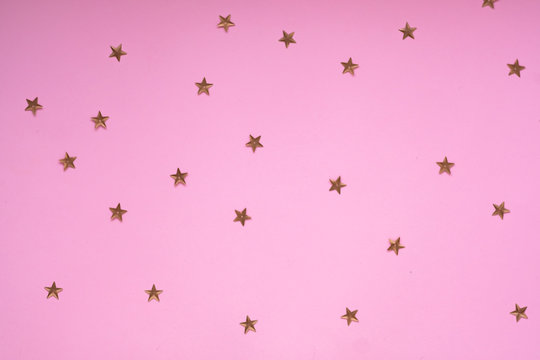 New Year or Christmas pattern flat lay top view Xmas holiday celebration pink paper golden sparkles confetti background. Template  banner for greeting card your text design 2020