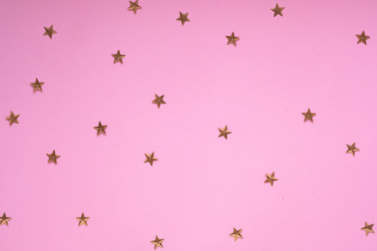 New Year or Christmas pattern flat lay top view Xmas holiday celebration pink paper golden sparkles confetti background. Template  banner for greeting card your text design 2020