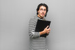 © Asier - Young employee man holding an inventory scared and afraid.