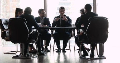 Wall Mural - Confident businessman speak to diverse business people at conference table