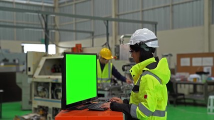Female asian Industrial Engineer Look at computer about research and analysis electronic device in the Industry Manufacturing Factory with Various Metalworking Processes.