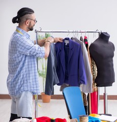 Wall Mural - Male tailor working in the workshop on new designs