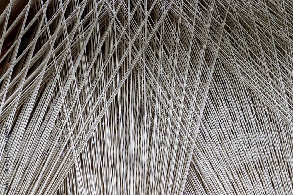 Close up of a lot of threads in a weaving machine called a loom - obrazy, fototapety, plakaty 