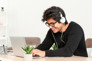 Asian programmer working on laptop in office