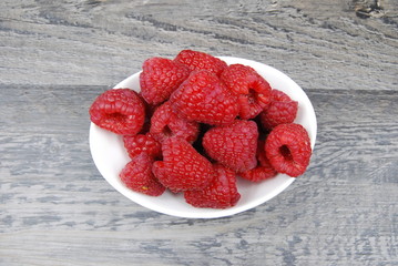 overhead view of fresh raspberries on rustic wood table