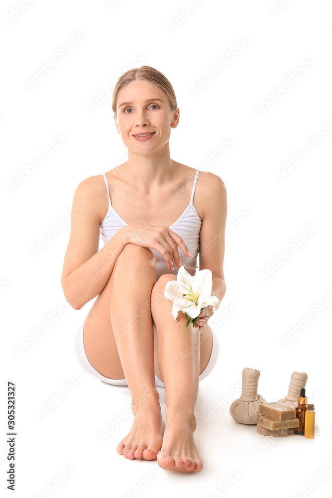 Beautiful woman and spa supplies on white background