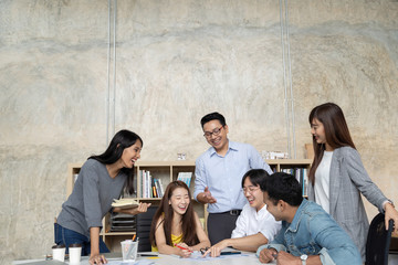 Wall Mural - Group of Asian business people team meeting in modern office working design planning and ideas concept