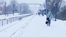 Commuters Walking Towards Their Wagon And Waiting For Their Morning Train During A Cold November Snowstorm.