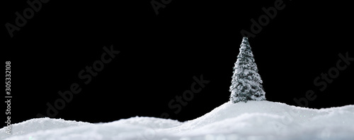 Fotomural Wintery landscape with single tree on glistening white snow drifts isolated on b