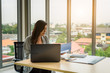 © APchanel - A Beautiful Confident asian young business woman working with laptop computer and checking document file on desk for successful business at office work place.