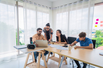 A Business people team looking at laptop computer and paper of work discussing for work diagram in office company with business meeting concept