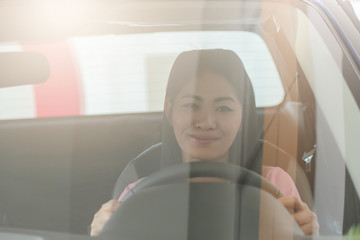 Asian girl smiling  relaxing sitting and prepare drive safety