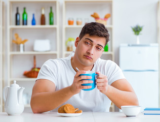 Canvas Print - Man falling asleep during his breakfast after overtime work