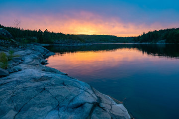 Karelia. Russia. Lake Ladoga. Ladoga skerries. Sunset on lake Ladoga. Rocky island. Landscape of Karelia at sunset. Northern nature. Travel to Russia.