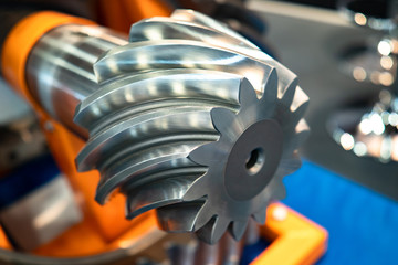 Poster - Metalworking. Metal gear close-up. Metal detail on a blurred background. Industrial concept. Machine technology. Production of Metalworking machines.