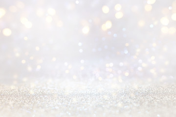 abstract background of glitter vintage lights . silver, gold and white. de-focused