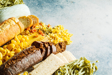 Canvas Print - Various pasta background. Bread and different pasta on gray-blue background, copy space.