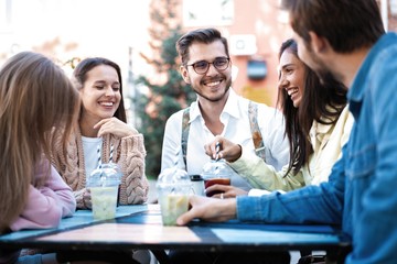 Group Of Friends Drinking Cocktails At Outdoor Bar