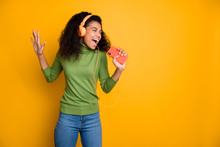 Photo Of Casual Cheerful Pretty Beautiful Youngster Singing Into Telephone Imagining It To Be Micriphone Screaming In Jeans Denim Isolated Yellow Vivid Color Background