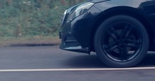 Reflecting Everything Around With Its Glossy Surface, The Premium Car Rides Asphalt Road Where You Can Observe The Suspension And How The Tires Perceive Driving Conditions