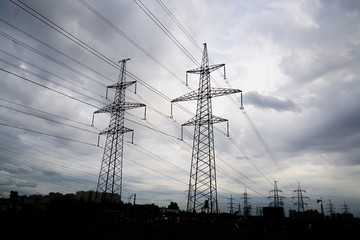  power transmission line in the city with cloudy sky