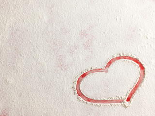 Wall Mural - Valentine love red heart shape made of flour on red background. Closeup.Christmas card.