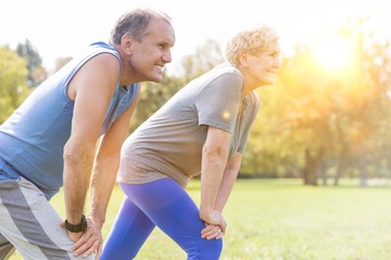 Determined senior couple exercising in park