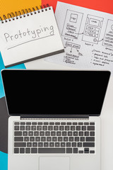 Poster - top view of notebook with prototyping lettering, laptop and website design template on abstract geometric background