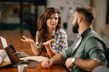 colleagues in office. businesswoman and businessman discussing work in office.