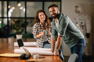 Wall Mural - Businesswoman and businessman discussing work in office. Two friends in working together.  