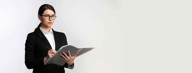 Wall Mural - Serious Girl Holding Folder Taking Notes Standing, White Background, Panorama