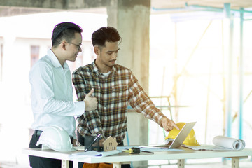 professional engineer planning with team young architect with laptop on wood table on plane project at site construction work