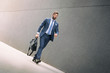 © Cherries - Stylish businessman walking outdoors and looking away