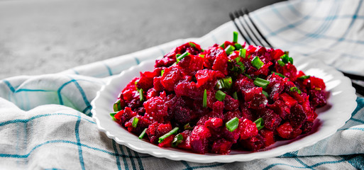 Wall Mural - Russian cuisine: beetroot salad with Carrots, Pickles and green Onion in white plate