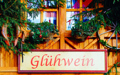 Sticker - Hot Gluhwein name plate on Christmas Market at Gendarmenmarkt square in Winter Berlin, Germany. Advent Fair Decoration and Stalls with Crafts Items on Bazaar. German street Xmas and holiday