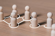 © Mizkit - Social connections by white lines with people figurines , Call for cooperation creating a new team and action contacts communication  in society