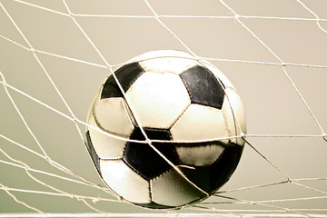 close up of scoring goal soccer goal against gray background