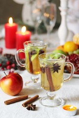 Sticker - christmas hot cider. hot winter drink Cranberry Apple Cider Punch. Garnish with apples, oranges, and cranberries. hot apple cider with spices on a festive table on Christmas or New Year.