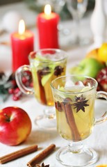 Sticker - christmas hot cider. hot winter drink Cranberry Apple Cider Punch. Garnish with apples, oranges, and cranberries. hot apple cider with spices on a festive table on Christmas or New Year.