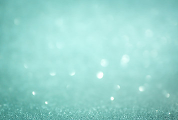Wall Mural - blue abstract glitter bokeh on black background